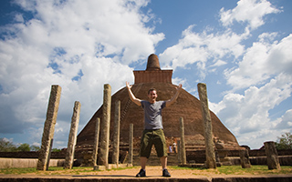 An overjoyed tourist in ancient temples in Polonnaruwa